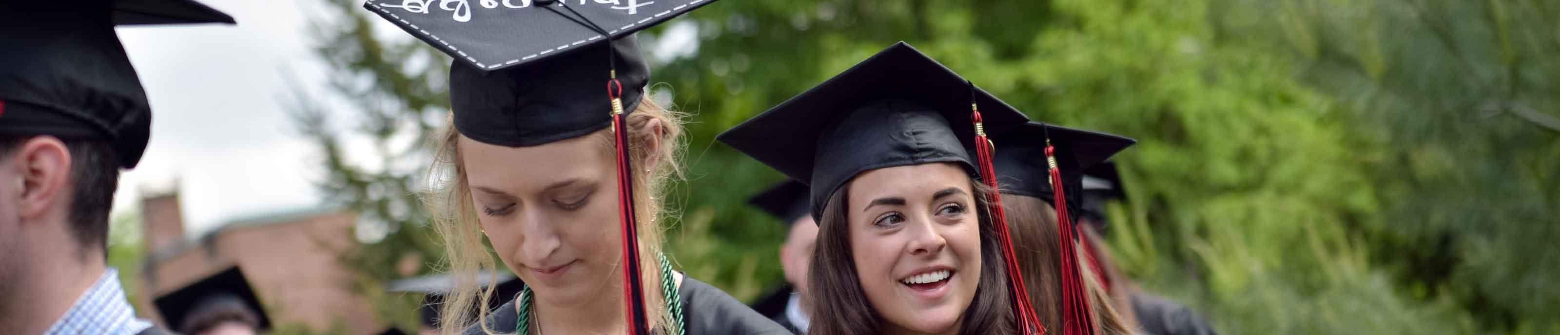 Graduate smiling in cap and gown